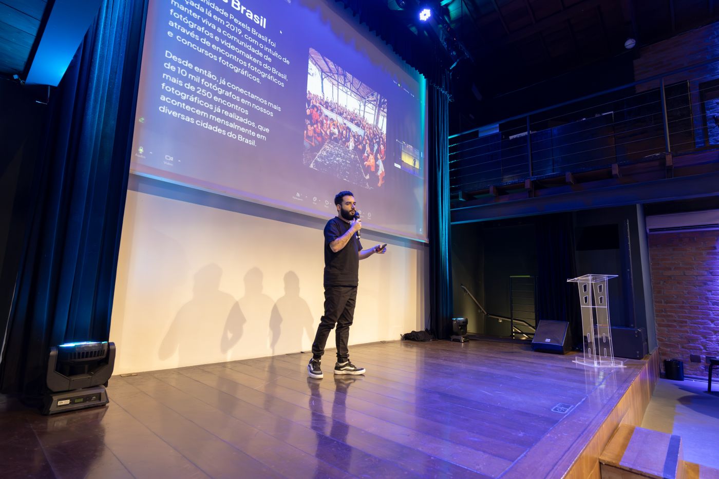 A speaker on the main stage with the presentation screen
