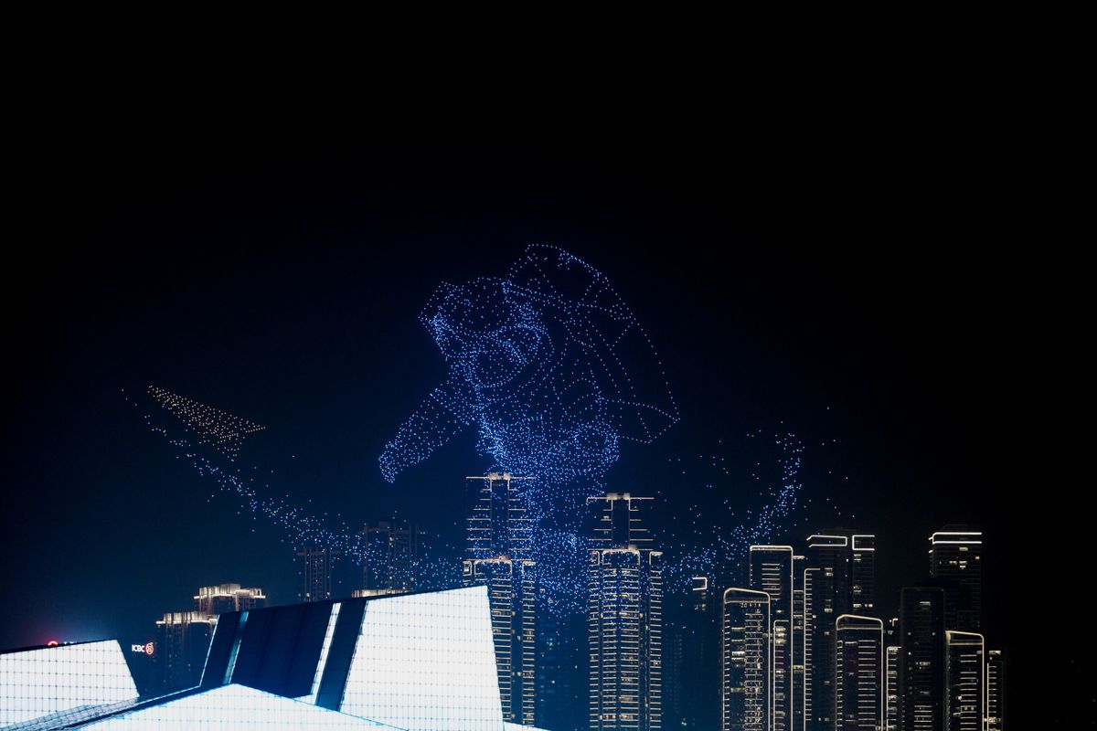 A drone light show over the city at night