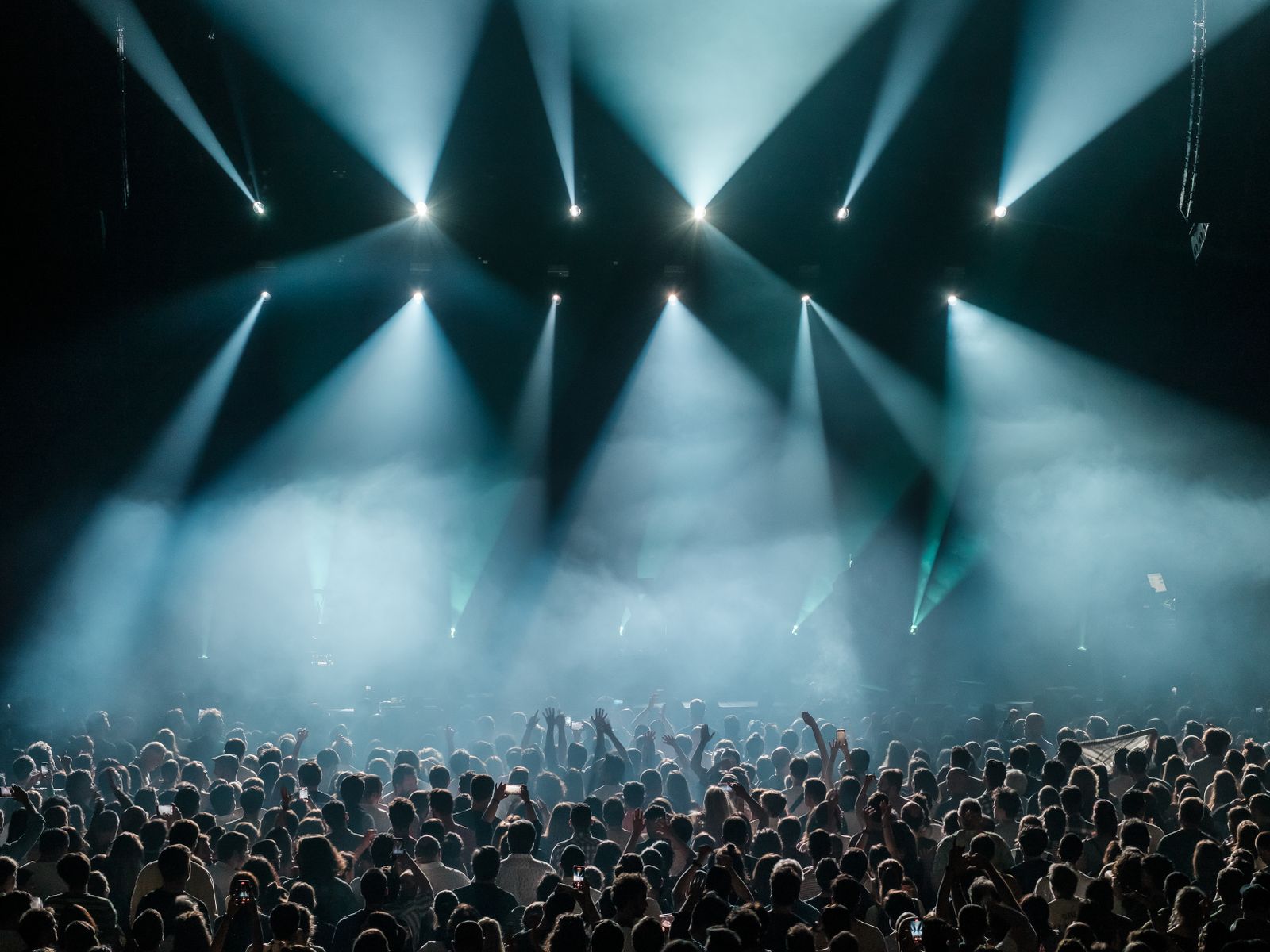 Stage lights sweeping over the crowd